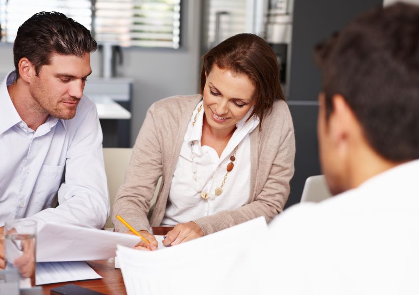 landlord-with-two-people-signing-lease